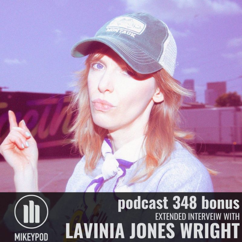 Portrait of Lavinia Jones Wright wearing a baseball cap and standing in an industrial setting.
