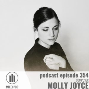 Black and white portrait of Molly Joyce. She has long dark hair which is pulled back. She is looking down toward the right corner of the image. Her hands are clasped against her chest. There is a light colored bar at the bottom of the image containing the text "Podcast Episode 354; Composer; Molly Joyce"